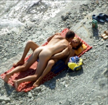 Пара нудистов занимается сексом прямо на диком пляже